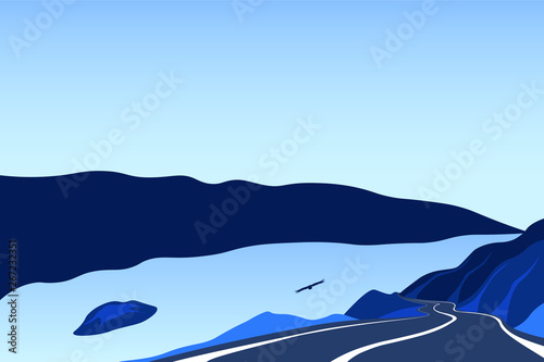 The road along the river. Asphalt road on the edge of the cliff. Mountain landscape with a trail going into the distance. Adventure and trip background with blue sky.