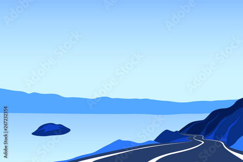 The road along the lake. Asphalt road on the edge of the cliff. Mountain landscape with a trail going into the distance. Adventure and trip background with blue sky.