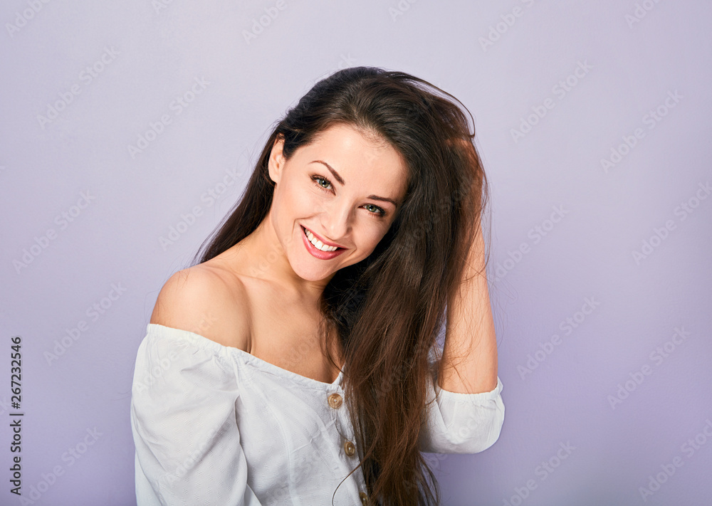 Beautiful natural toothy smiling woman looking with happy in white shirt with long curly hairstyle. Closeup portrait Beautiful natural toothy smiling woman looking with happy in white shirt with long curly hairstyle. Closeup portrait