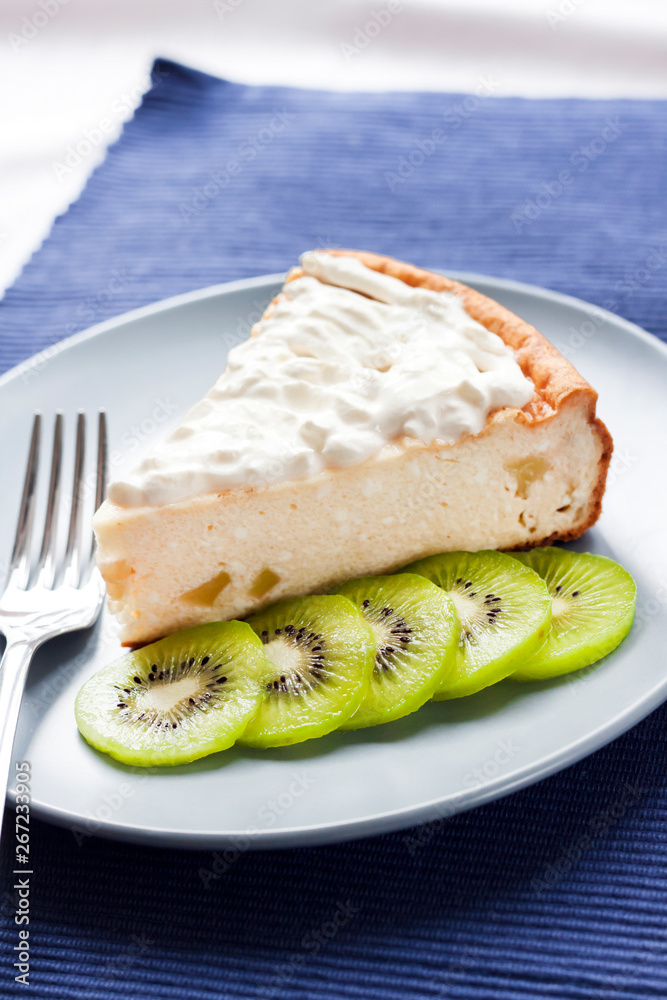 Homemade cottage cheese and semolina cake with kiwi fruit and cream