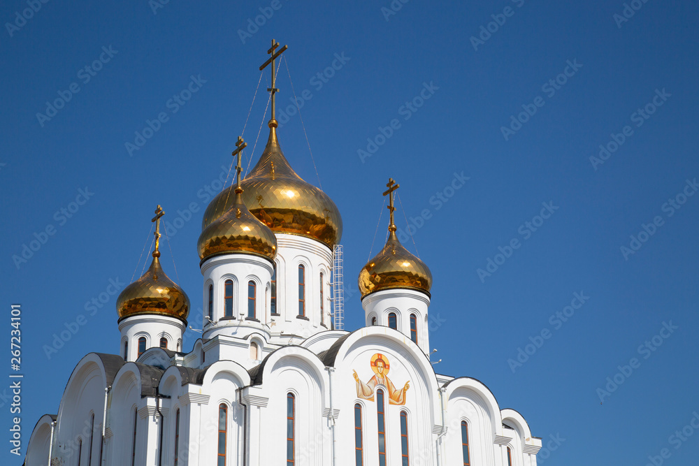 The Golden domes of the Church in the blue sky.