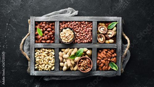 Set nuts and dried fruit in a wooden box. Top view. Free space for your text.