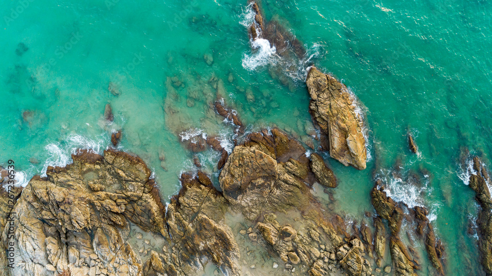 Aerial view drone shot of seascape scenic off beach in phuket thailand with wave crashing on the rocks