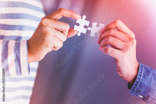 jigsaw puzzle holding by two people hands, together to success concept © angyim