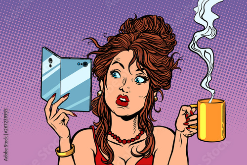 Woman drinking coffee or tea. A smartphone with a foldable flexible display