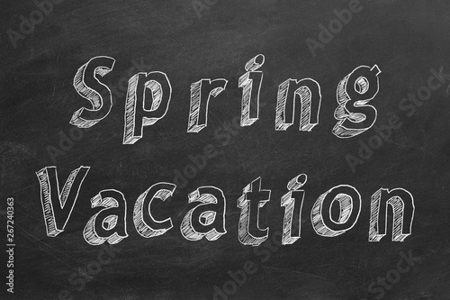 Hand drawing text "Spring Vacation" on blackboard