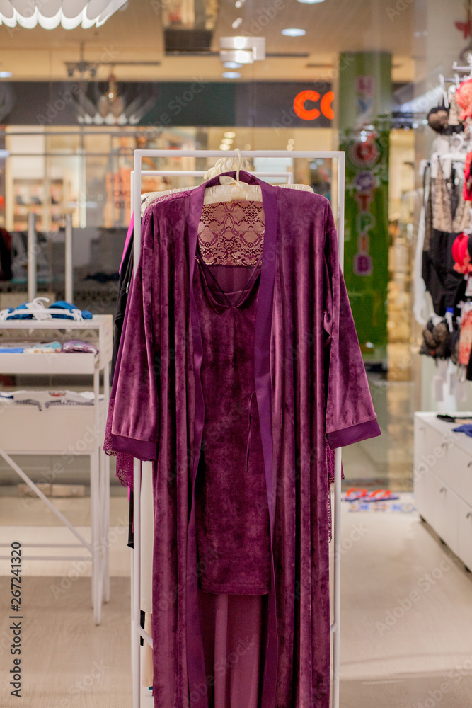 Female red satin nightgown at the store. Advertise, Sale, Fashion concept. Female red satin nightgown at the store. Advertise, Sale, Fashion concept.