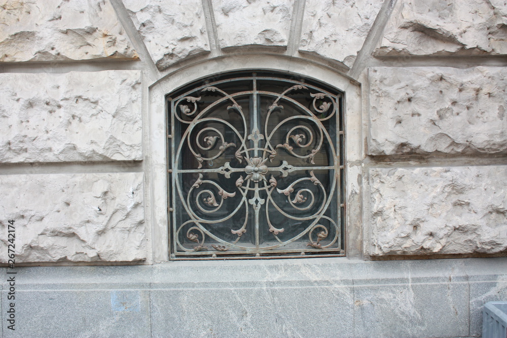 design of a metal lattice of a window of an old building in St. Petersburg  