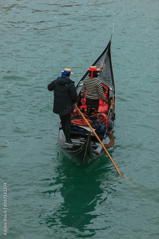 Traditional Gondola Drivers in Venice, Italy, on the turquoise Water of the Canale Grande (