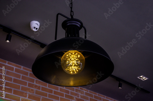 Close up incandescent lamp shining, Yellow light of lamp hang on ceiling
