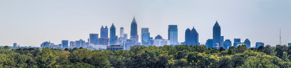 Downtown Atlanta Skyline showing several prominent buildings and hotels under a blue sky as seen from Buckhead in North Atlanta