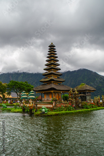 Moody scenic landscape view of Pura Ulun Danu Bratan, Hindu water temple on Bratan lake, tourist most popular attraction in Bali island, Indonesia.