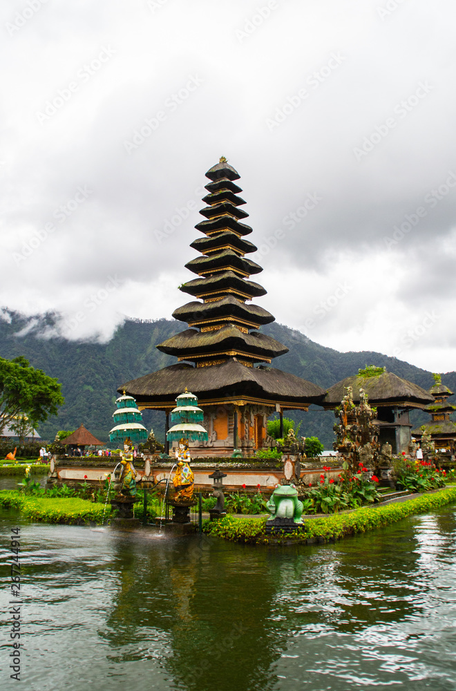 Moody scenic landscape view of Pura Ulun Danu Bratan, Hindu water temple on Bratan lake, tourist most popular attraction in Bali island, Indonesia. Moody scenic landscape view of Pura Ulun Danu Bratan, Hindu water temple on Bratan lake, tourist most popular attraction in Bali island, Indonesia.