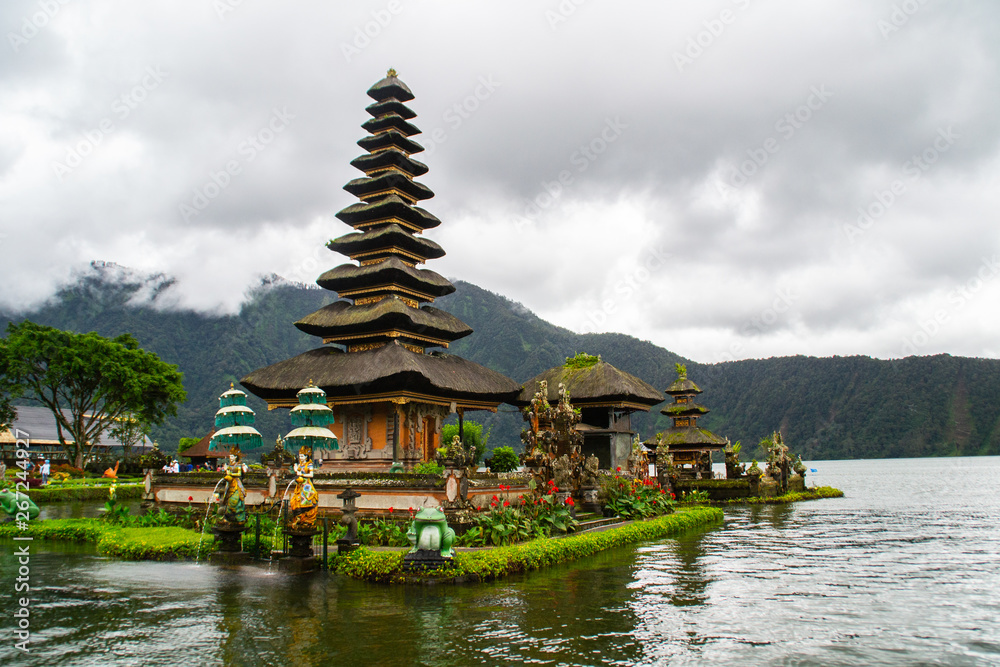 Moody scenic landscape view of Pura Ulun Danu Bratan, Hindu water temple on Bratan lake, tourist most popular attraction in Bali island, Indonesia. Moody scenic landscape view of Pura Ulun Danu Bratan, Hindu water temple on Bratan lake, tourist most popular attraction in Bali island, Indonesia.