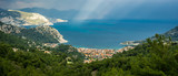 Aerial view from Turunc Bay, with sunbeam and cloudy sky. Marmaris, Turkey. Holiday and summer background. Curvy road and forest detail. Panoramic image.