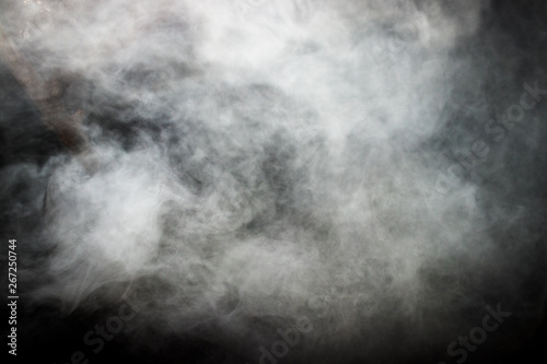 Smoke and dense fog on black background.