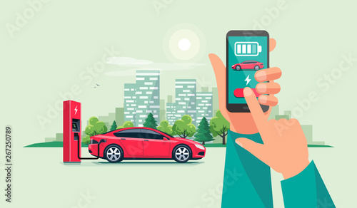 Modern vector illustration of autonomous smart electric car charging at charger station controlled via smartphone charging app. Hands holding phone with smart battery charge application. City skyline.