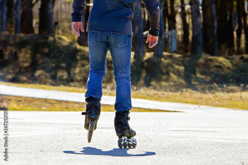 adult man roller skating in the city park on a sunny day