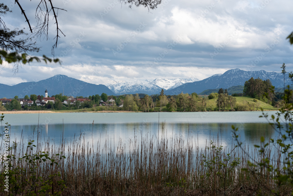Scenic Bavarian town in spring with lake and alps 
