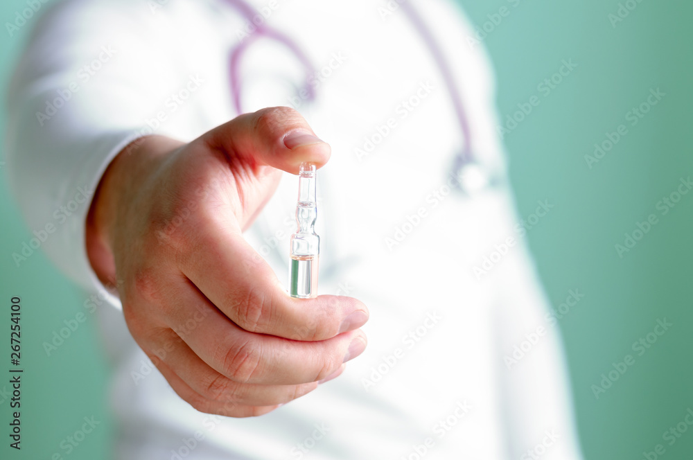 The doctor holds out the capsule in his hand. Medical care concept. Selective focus. The doctor holds out the capsule in his hand. Medical care concept. Selective focus.