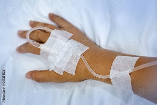 The patient hand with IV solution,for treatment,blurry light around