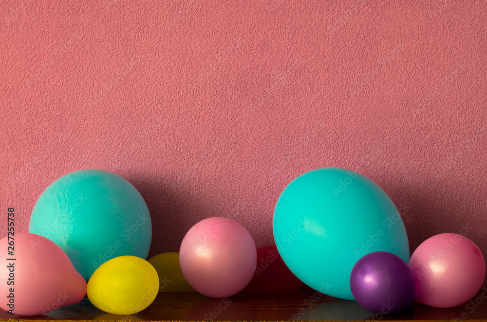 Multicolored balloons on a pink background. Empty space for your text Multicolored balloons on a pink background. Empty space for your text