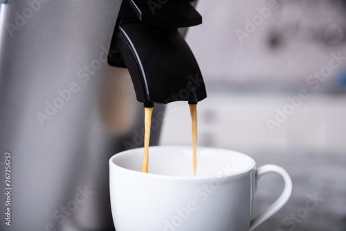 Espresso Machine Pouring Coffee Into A White Cup