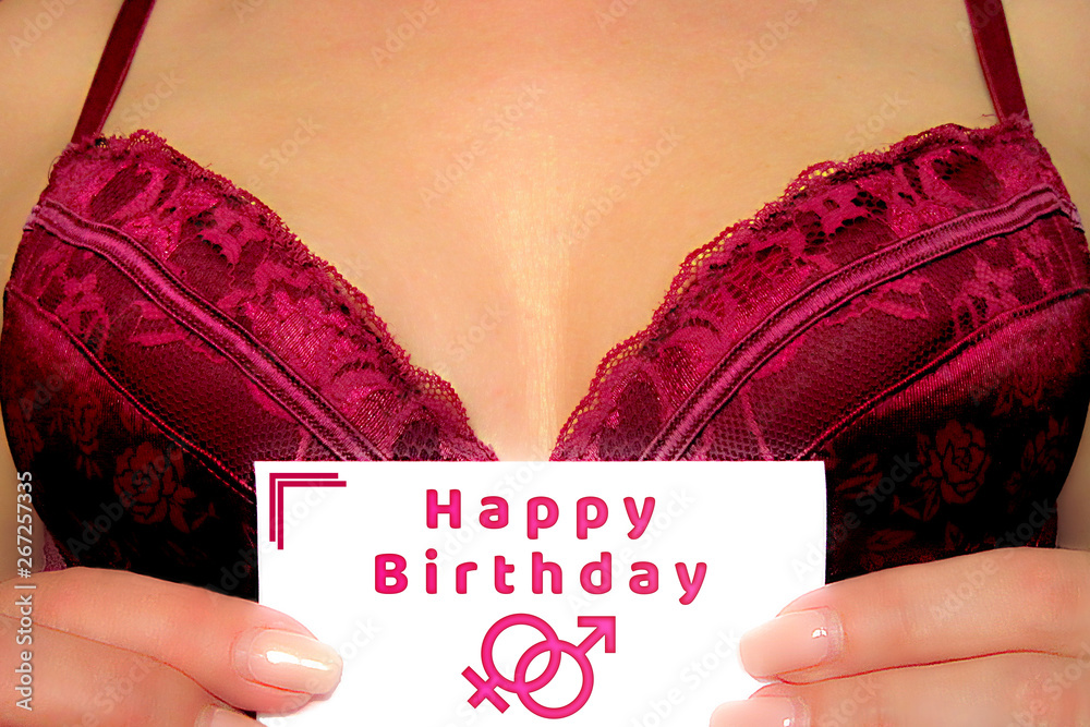 Happy birthday greeting postcard. Girl holds congratulation card in front  of bust in sexy bra or glamour decollate dress. Closeup cute erotic  decoration message image Stock Photo | Adobe Stock