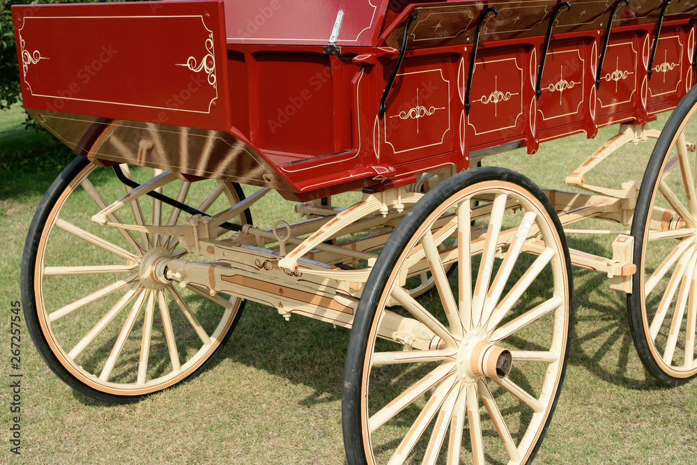 restored red and pale yellow wooden horse drawn wagon