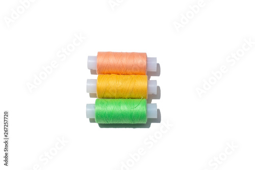 three spools of thread and different colors isolated