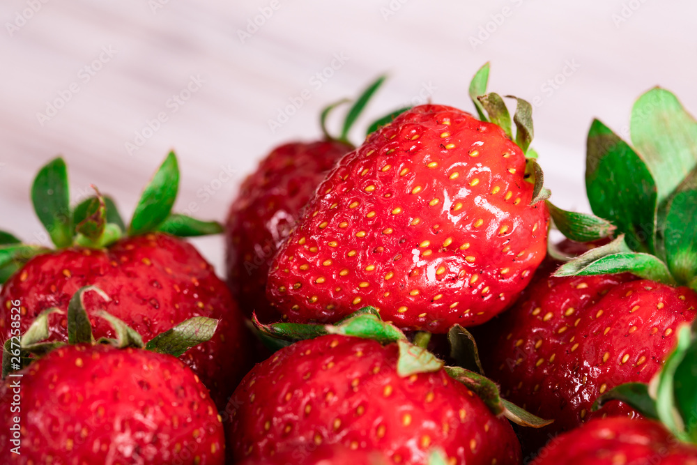 Red juicy strawberry lies on a saucer. Seasonal berries. Red juicy strawberry lies on a saucer. Seasonal berries.