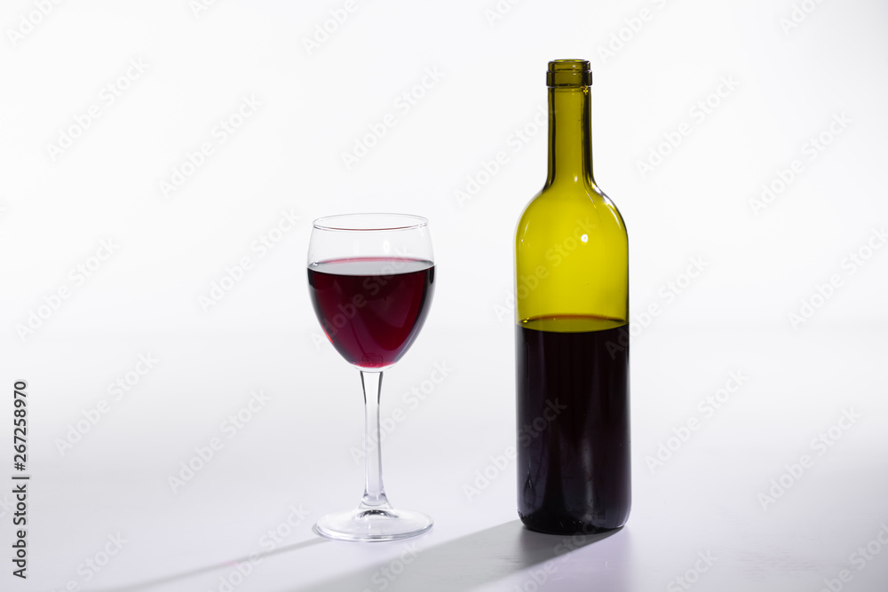 Bottle and glass with red wine on white background Bottle and glass with red wine on white background