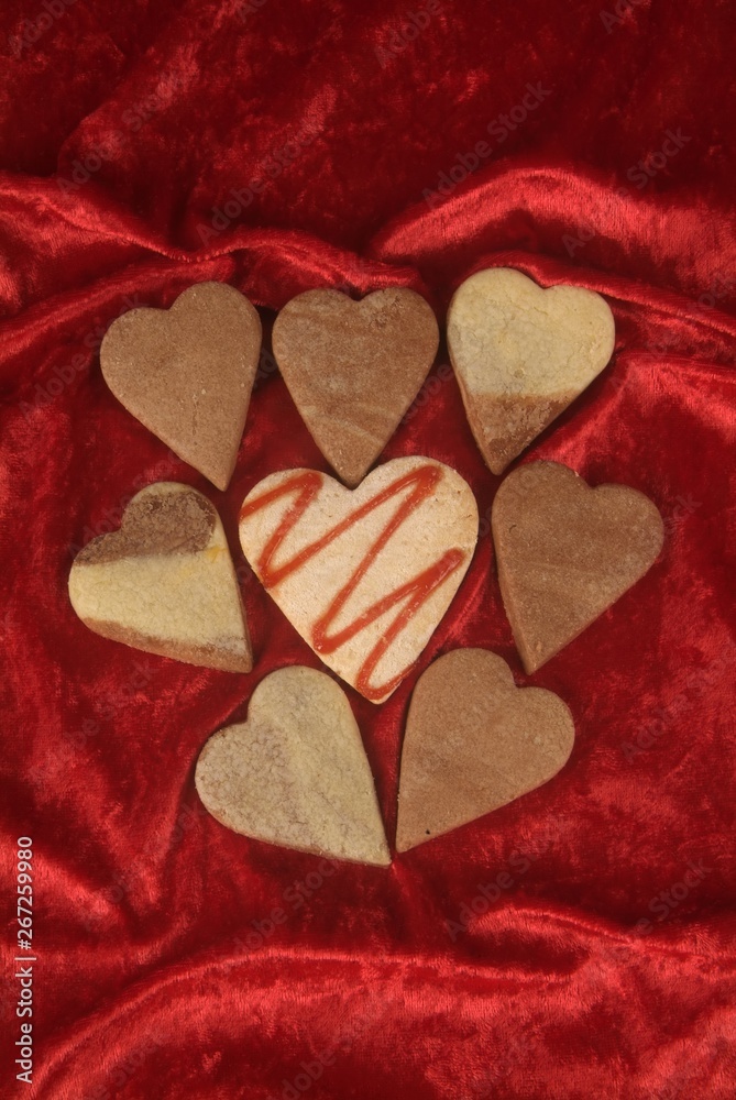 Fototapeta premium Symbol of flower of cookie in form of heart with red jam, copyspace on wooden table.