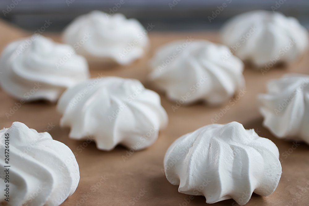 Meringues on a white plate. Dessert Pavlova.