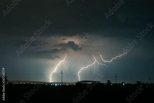 Beautiful but dangerous lightning strikes in central Transylvania, Romania. Strong thunderstorms on an evening in the month of May in eastern Europe.