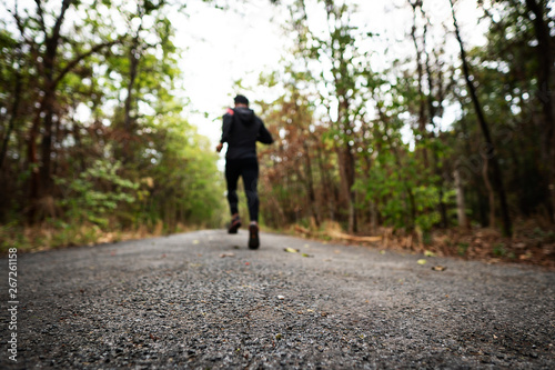 Runners are running parks with warm light of sunset