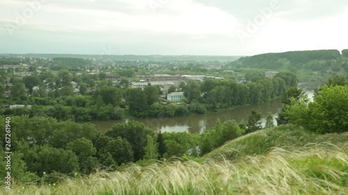 Evening panorama of a provincial town from the river bank in Russia