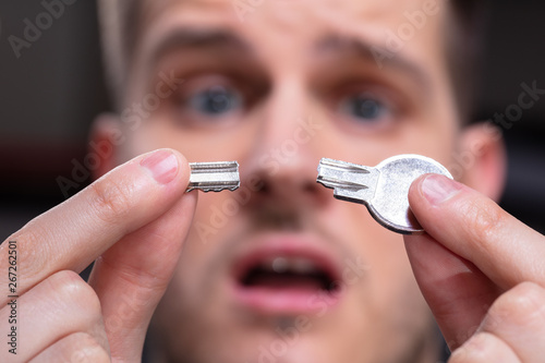 Shocked Person Showing Broken Key photo