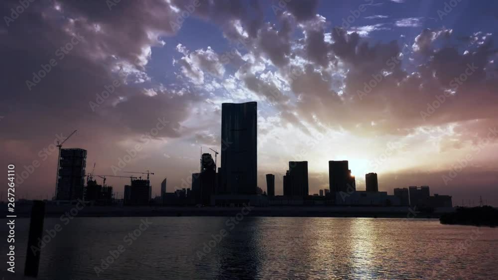 Time lapse of city skyline and work district with modern skyscrapers at sunset - Al Reem Abu Dhabi Time lapse of city skyline and work district with modern skyscrapers at sunset - Al Reem Abu Dhabi