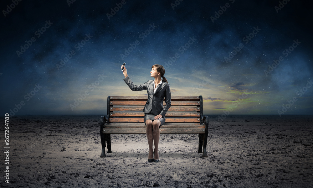 Young woman in business suit holding smartphone Young woman in business suit holding smartphone