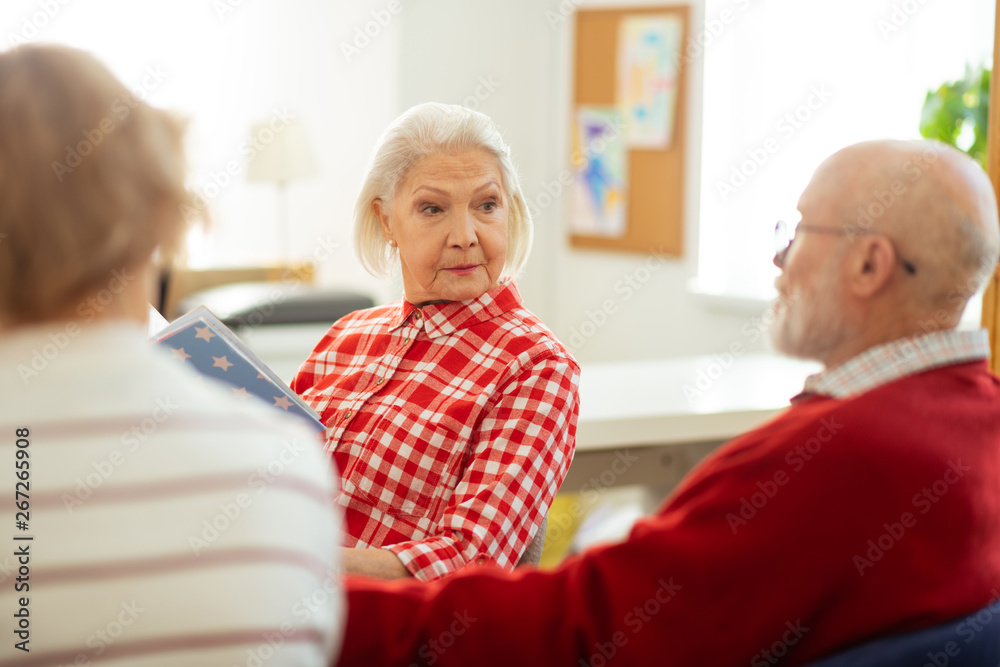 Smart serious aged woman looking at her friend Smart serious aged woman looking at her friend