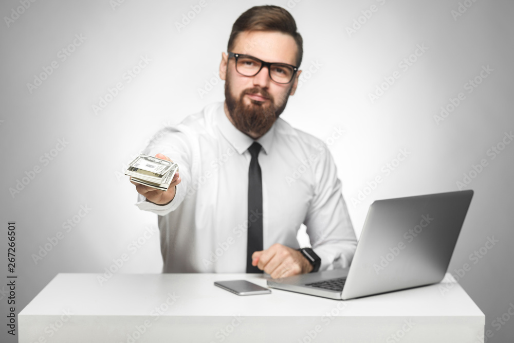 Money are yours! Portrait of handsome richman bearded young big boss in white shirt and black tie are sitting in office giving your a lot of money, your bonus, looking at camera, isolated, indoor Money are yours! Portrait of handsome richman bearded young big boss in white shirt and black tie are sitting in office giving your a lot of money, your bonus, looking at camera, isolated, indoor