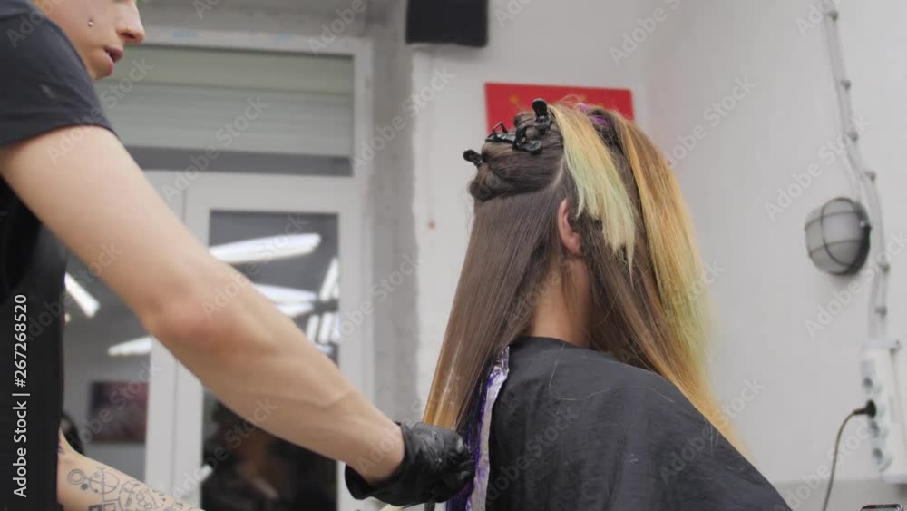 Professional woman hairdresser making creative hairstyle to girl in beauty salon. Professional woman hairdresser making creative hairstyle to girl in beauty salon.