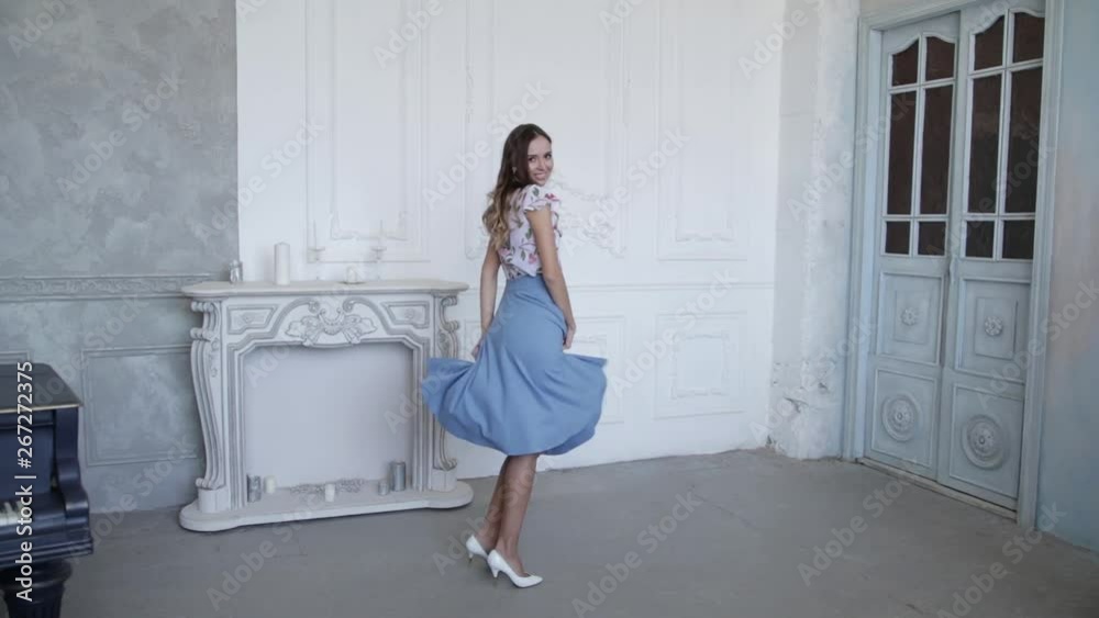 Young funny girl in a beautiful dress dancing and laughing , spinning and having fun. Slow motion Young funny girl in a beautiful dress dancing and laughing , spinning and having fun. Slow motion