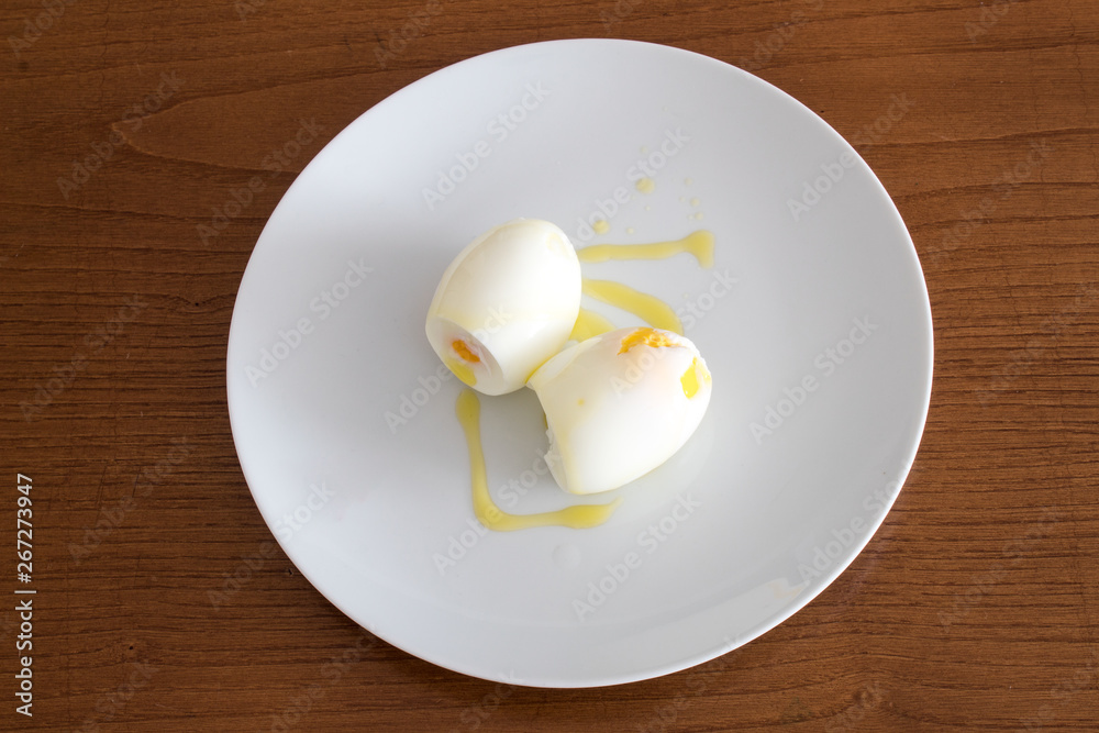 Plate of boiled eggs on wood background, top view Plate of boiled eggs on wood background, top view