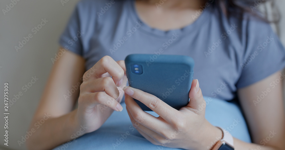 Close up of woman use mobile phone at home Close up of woman use mobile phone at home