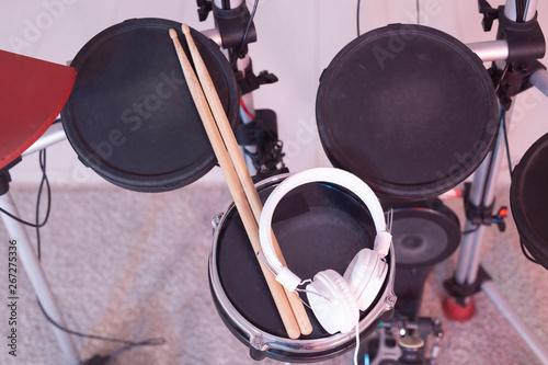 Music, hobby, musical instruments concept - drum with drumsticks and headphones, top view © satura_