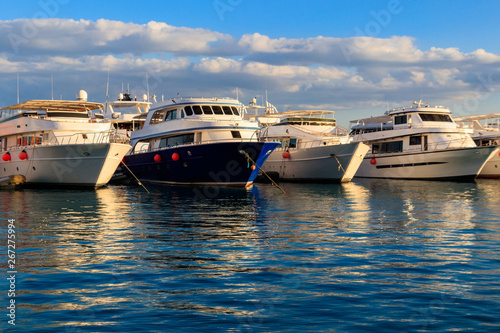 White yachts in the sea harbor of Hurghada, Egypt. Port with tourist boats on the Red Sea