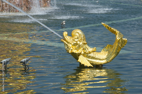 Moscow, Russia - may 7, 2019: Golden Dolphin in the pool of the fountain "Friendship of peoples" at VDNH