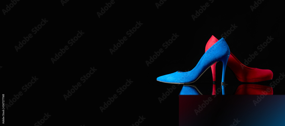 Blue and red women's corduroy shoes on a black background. - obrazy, fototapety, plakaty 